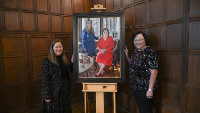 Sally WongAvery (R) and her daughter Natasha Wong (L) stand beside a new portrait.