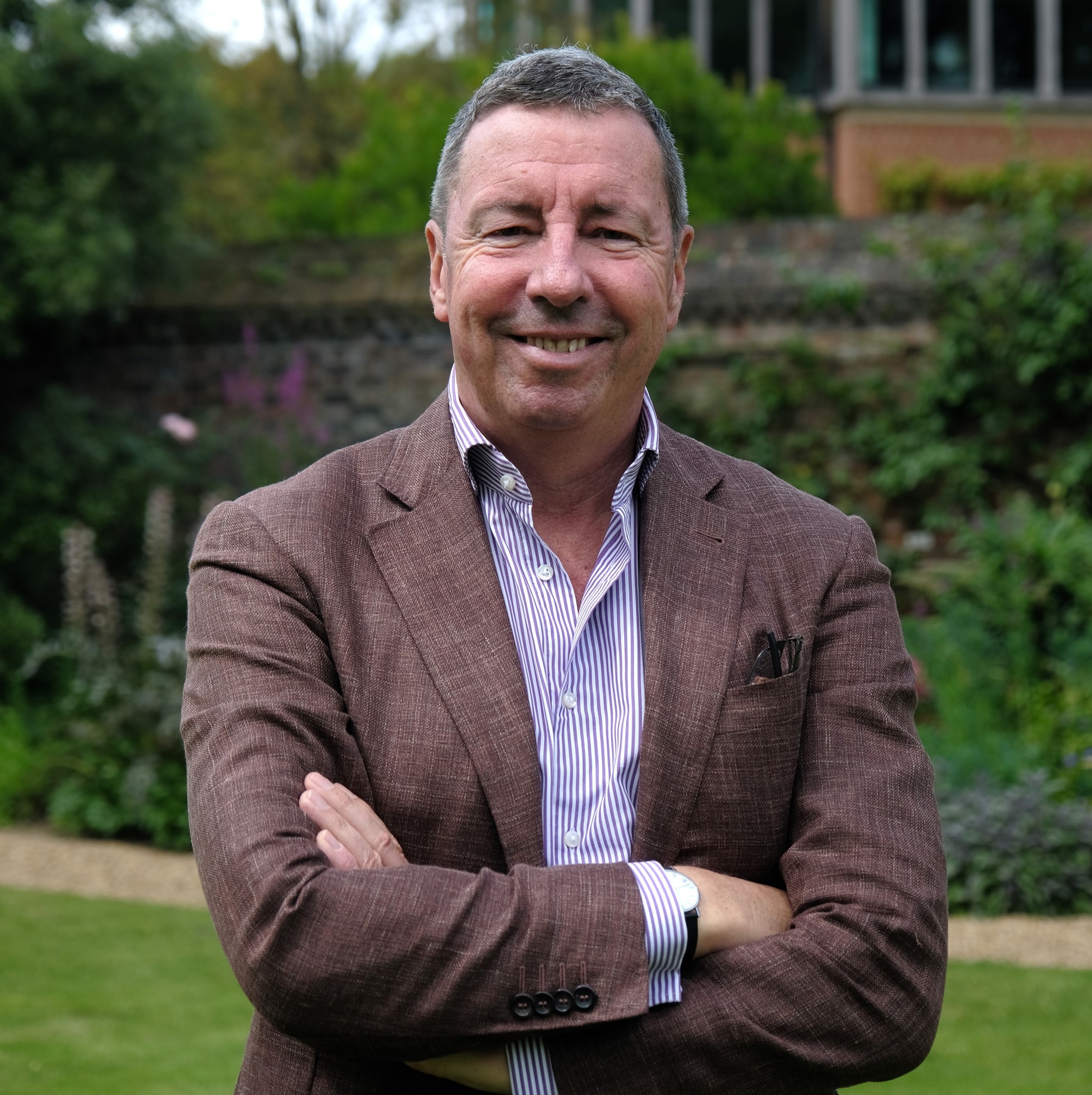 Professor Campbell McLachlan standing in Trinity Hall Fellows' Garden