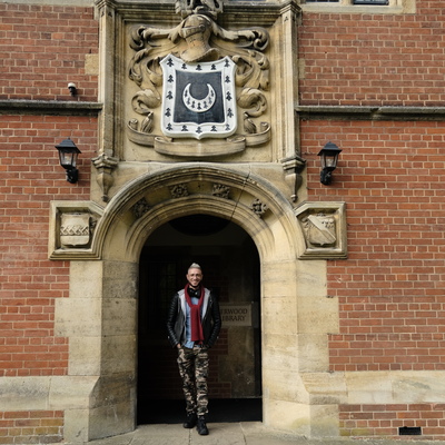 First Nation Writer in residence Daniel Browning standing outside the Jerwood Library at Trinity Hall, Cambridge.